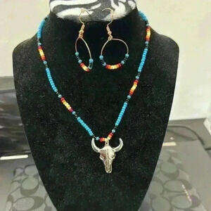 Handmade necklace and earrings by my daughter. Bull skull Aztec looking